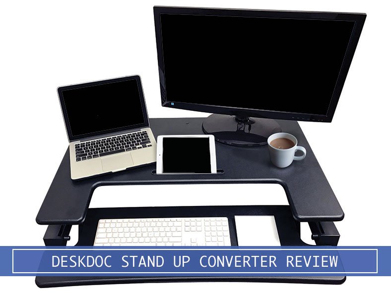 apple macbook pro, apple ipad, and monitor on the deskdoc standing desk with a cup of coffee