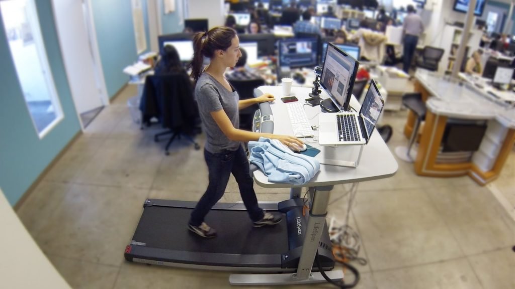 woman on a treadmill and standing desk working